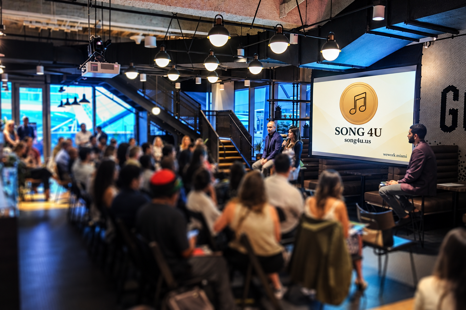 Song4U panel event at WeWork Miami, with the Song4U logo on the screen and an audience listening
