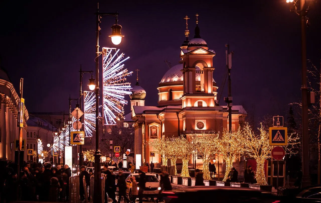A city illuminated with festive Christmas lights at night