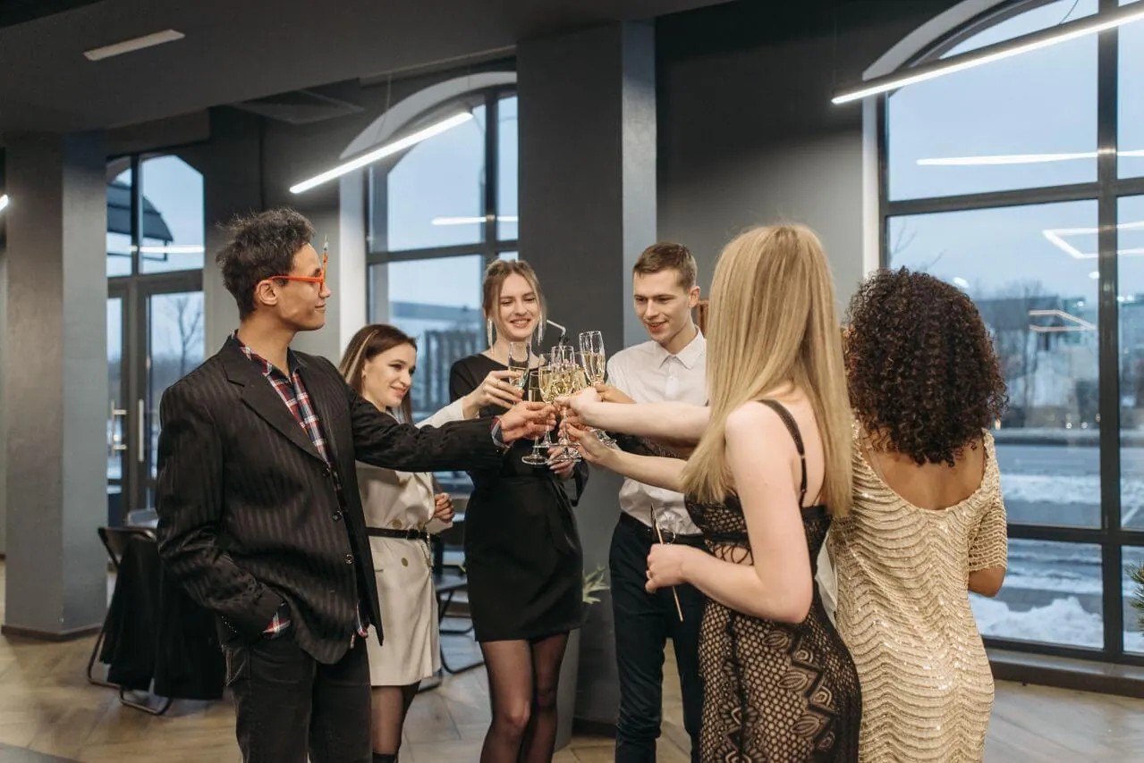 Colleagues celebrating together in a bright office